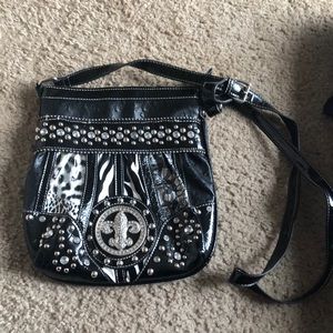 Crossbody jewel black purse with animal print.